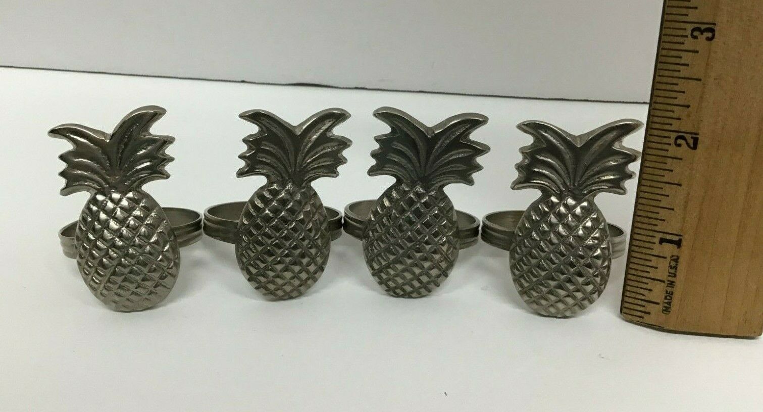 Metal Pewter Pineapple Shaped Napkin Rings Set Of 4   614e330bf0b9d9b582c4a19d 